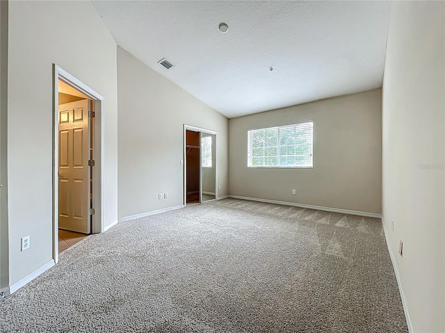 10746 Regent Square Dr Unit 1502, Orlando, FL 32825 - unfurnished bedroom with lofted ceiling, carpet floors, baseboards, and a spacious closet