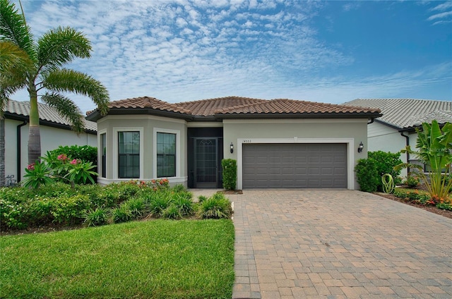 14553 Eagle Branch Dr, Nokomis, FL 34275 - view of front of home with stucco siding, an attached garage, decorative driveway, and a front lawn