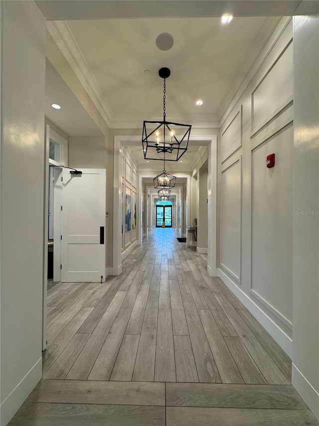 14553 Eagle Branch Dr, Nokomis, FL 34275 - corridor featuring a chandelier, light wood finished floors, ornamental molding, and baseboards