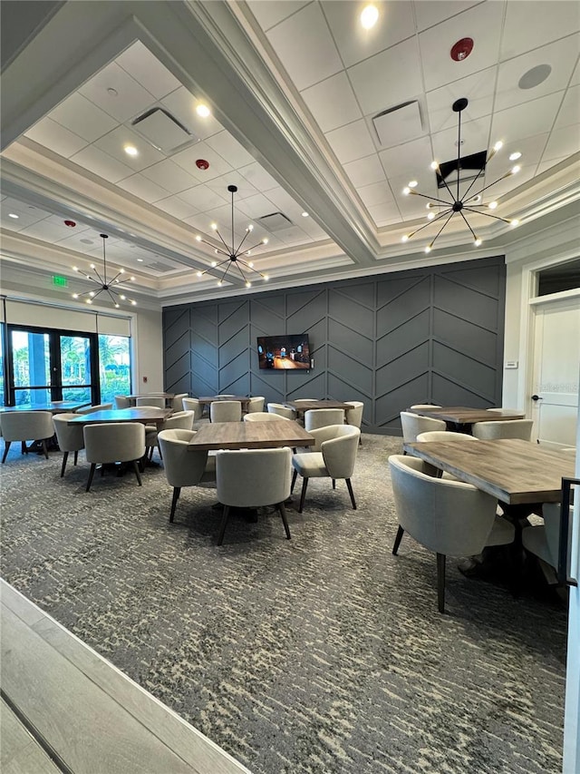 14553 Eagle Branch Dr, Nokomis, FL 34275 - carpeted dining space with a chandelier, a raised ceiling, and ornamental molding
