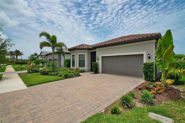 14553 Eagle Branch Dr, Nokomis, FL 34275 - mediterranean / spanish home with an attached garage, a tile roof, driveway, and stucco siding