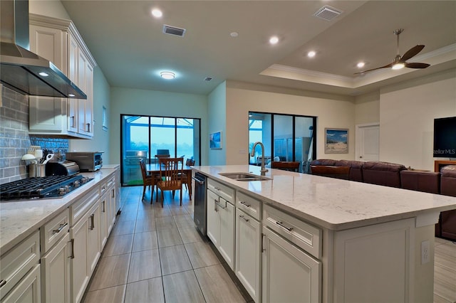 14553 Eagle Branch Dr, Nokomis, FL 34275 - kitchen featuring a sink, wall chimney exhaust hood, decorative backsplash, stainless steel appliances, and a ceiling fan