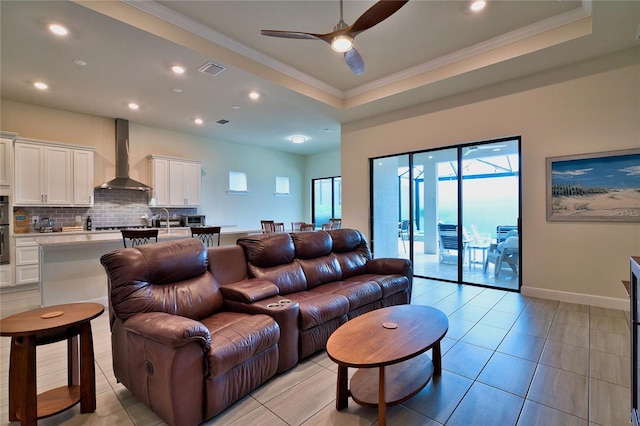 14553 Eagle Branch Dr, Nokomis, FL 34275 - living room with a raised ceiling, crown molding, a ceiling fan, recessed lighting, and light tile patterned flooring
