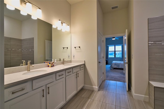 14553 Eagle Branch Dr, Nokomis, FL 34275 - bathroom featuring double vanity, baseboards, ensuite bath, a high ceiling, and a ceiling fan