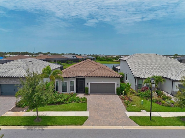 14553 Eagle Branch Dr, Nokomis, FL 34275 - view of front facade featuring a garage, a residential view, a tile roof, and a front lawn