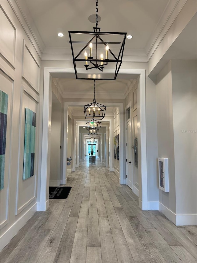 14553 Eagle Branch Dr, Nokomis, FL 34275 - corridor featuring a chandelier, light wood-type flooring, heating unit, ornamental molding, and baseboards
