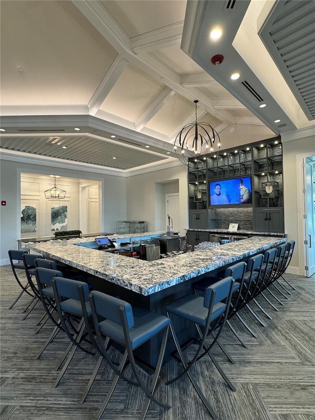 14553 Eagle Branch Dr, Nokomis, FL 34275 - kitchen with carpet floors, light stone countertops, a chandelier, recessed lighting, and a kitchen bar