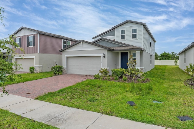 5288 Stephs Field St, Saint Cloud, FL 34771 - traditional home with decorative driveway, a garage, stucco siding, a front yard, and stone siding