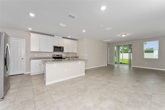 5288 Stephs Field St, Saint Cloud, FL 34771 - kitchen with appliances with stainless steel finishes, open floor plan, a center island with sink, baseboards, and recessed lighting