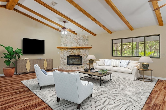 11323 Kijik Trl, Groveland, FL 34736 - living room with wood finished floors, a ceiling fan, and a stone fireplace