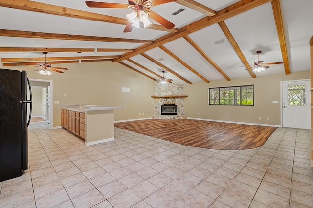 11323 Kijik Trl, Groveland, FL 34736 - unfurnished living room with a ceiling fan, light tile patterned floors, and a stone fireplace