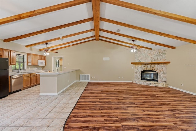 11323 Kijik Trl, Groveland, FL 34736 - kitchen featuring dishwasher, ceiling fan, white microwave, light countertops, and freestanding refrigerator
