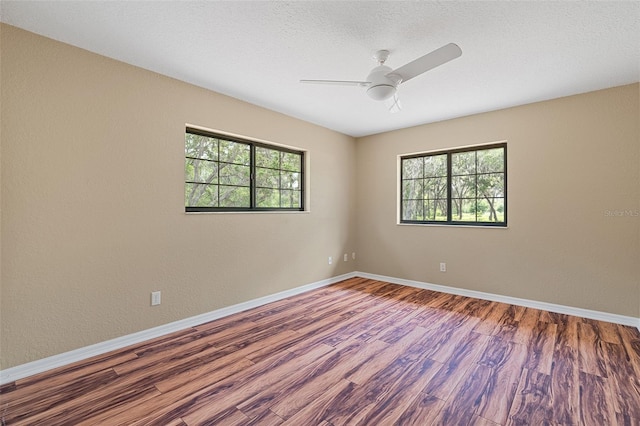 11323 Kijik Trl, Groveland, FL 34736 - unfurnished room with healthy amount of natural light, wood finished floors, and a ceiling fan