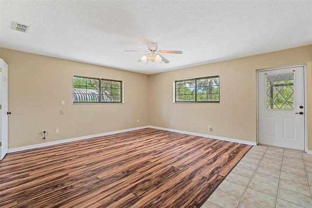 11323 Kijik Trl, Groveland, FL 34736 - foyer featuring ceiling fan, light wood-type flooring, and a textured ceiling