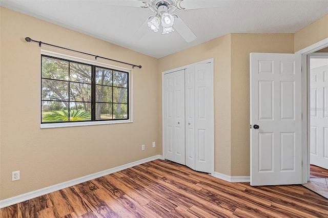 11323 Kijik Trl, Groveland, FL 34736 - unfurnished bedroom with wood finished floors, a closet, and ceiling fan