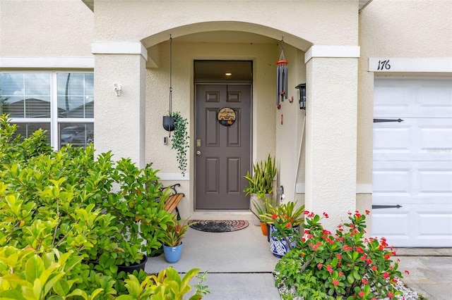 176 Sofia Ln, Lake Alfred, FL 33850 - entrance to property featuring stucco siding and a garage