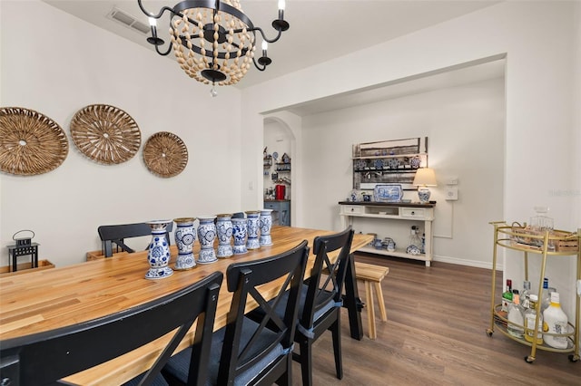 176 Sofia Ln, Lake Alfred, FL 33850 - dining space featuring arched walkways, a chandelier, wood finished floors, and baseboards