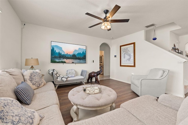 176 Sofia Ln, Lake Alfred, FL 33850 - living area featuring arched walkways, a ceiling fan, dark wood-style floors, and baseboards