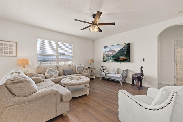 176 Sofia Ln, Lake Alfred, FL 33850 - living room with arched walkways, wood finished floors, a ceiling fan, and baseboards