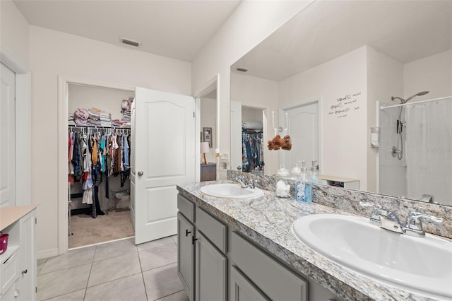 176 Sofia Ln, Lake Alfred, FL 33850 - full bath featuring double vanity, a walk in closet, a shower with shower curtain, and tile patterned flooring