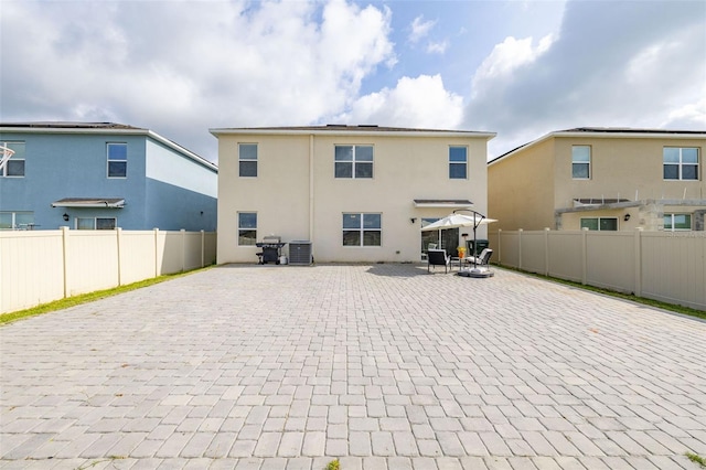 176 Sofia Ln, Lake Alfred, FL 33850 - rear view of property with a patio area, central air condition unit, a fenced backyard, and stucco siding
