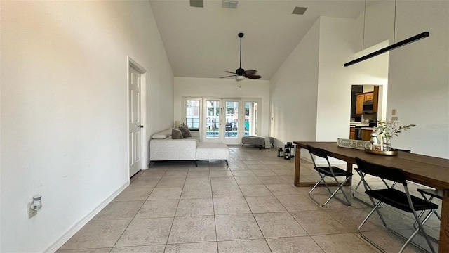 3901 Ballinore Pl, Gotha, FL 34734 - living room with high vaulted ceiling, french doors, ceiling fan, baseboards, and light tile patterned floors