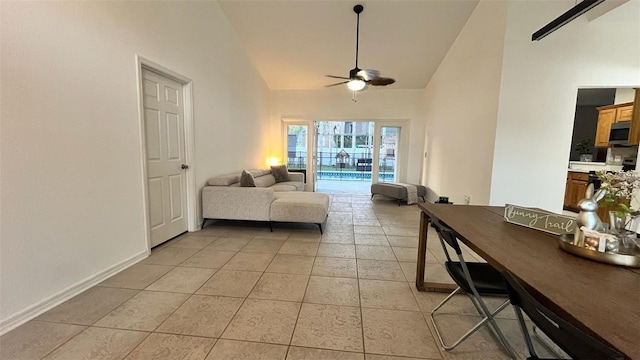 3901 Ballinore Pl, Gotha, FL 34734 - living area with a ceiling fan, high vaulted ceiling, light tile patterned floors, and baseboards
