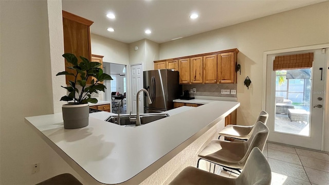 3901 Ballinore Pl, Gotha, FL 34734 - kitchen with stainless steel refrigerator with ice dispenser, a sink, a peninsula, decorative backsplash, and recessed lighting