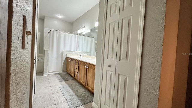 3901 Ballinore Pl, Gotha, FL 34734 - bathroom with tile patterned flooring, double vanity, a shower with shower curtain, and a textured wall