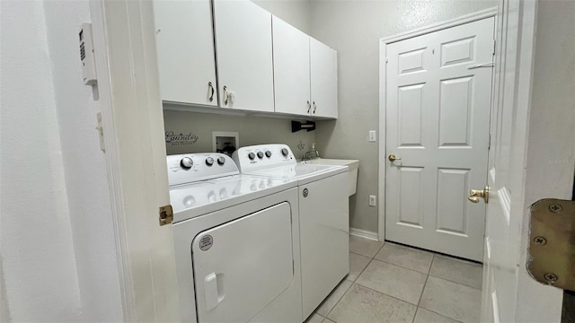 3901 Ballinore Pl, Gotha, FL 34734 - washroom featuring washing machine and dryer, cabinet space, and light tile patterned flooring