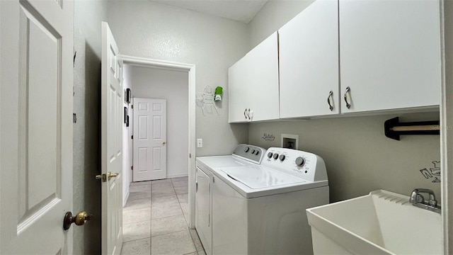 3901 Ballinore Pl, Gotha, FL 34734 - laundry area featuring separate washer and dryer, cabinet space, and light tile patterned flooring