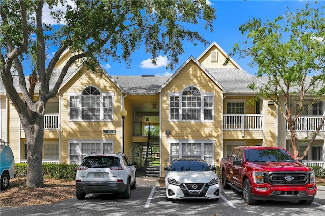 1025 S Hiawassee Rd Unit 2225, Orlando, FL 32835 - multi unit property featuring uncovered parking, stairway, and roof with shingles