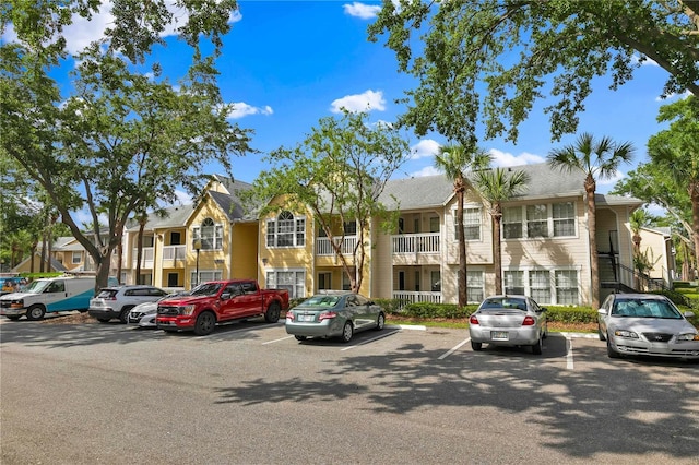 1025 S Hiawassee Rd Unit 2225, Orlando, FL 32835 - view of building exterior with uncovered parking and a residential view