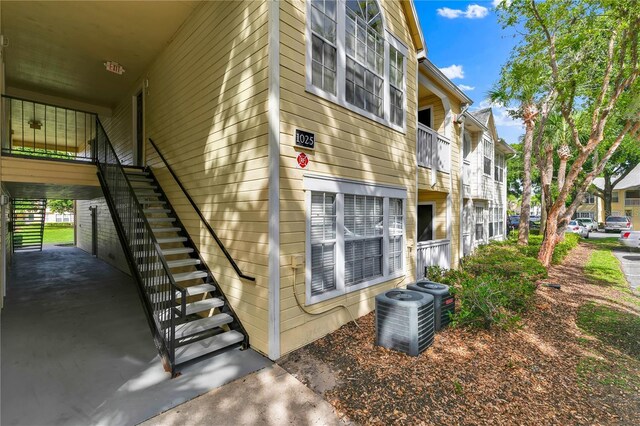 1025 S Hiawassee Rd Unit 2225, Orlando, FL 32835 - view of side of home featuring stairway and central air condition unit