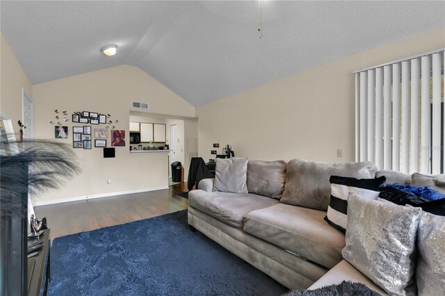 1025 S Hiawassee Rd Unit 2225, Orlando, FL 32835 - living room featuring vaulted ceiling, wood finished floors, a textured ceiling, and baseboards
