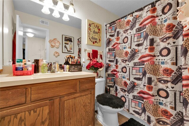1025 S Hiawassee Rd Unit 2225, Orlando, FL 32835 - bathroom featuring toilet, vanity, a shower with shower curtain, and tile patterned floors