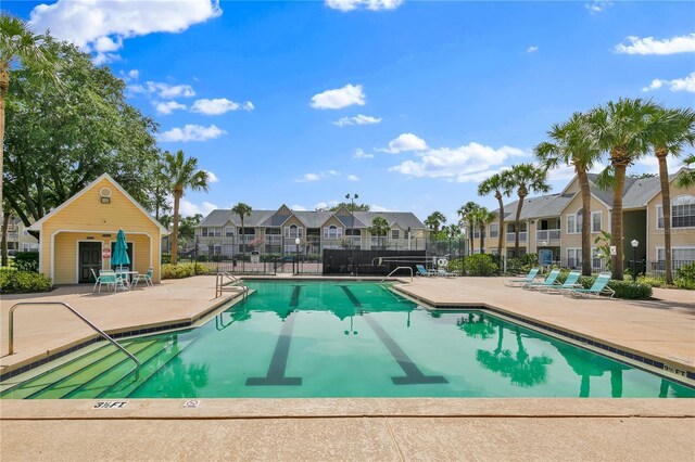 1025 S Hiawassee Rd Unit 2225, Orlando, FL 32835 - community pool featuring a residential view and a patio