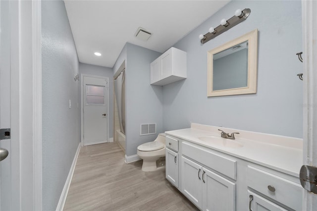 5015 Nassau Cir Unit 4, Orlando, FL 32808 - full bathroom with vanity, toilet, baseboards, wood finished floors, and shower / tub combo