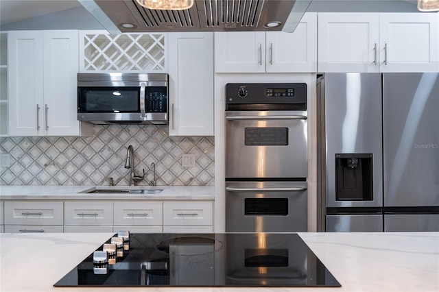 5015 Nassau Cir Unit 4, Orlando, FL 32808 - kitchen featuring stainless steel appliances, a sink, white cabinetry, backsplash, and light stone counters