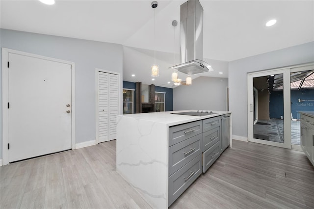 5015 Nassau Cir Unit 4, Orlando, FL 32808 - kitchen featuring gray cabinetry, island exhaust hood, black electric cooktop, light wood-style flooring, and a center island