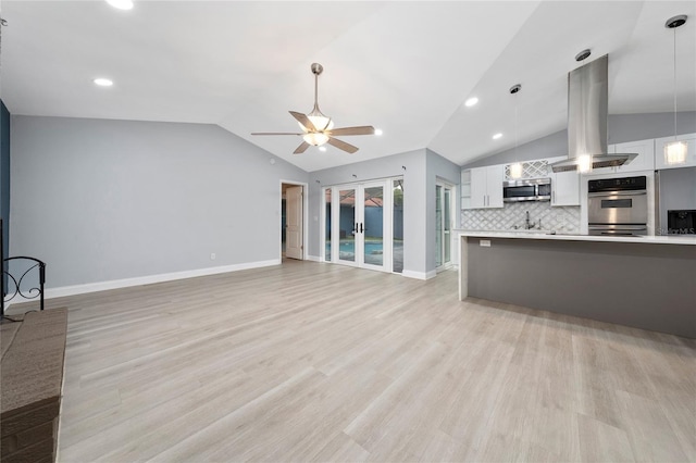 5015 Nassau Cir Unit 4, Orlando, FL 32808 - unfurnished living room with lofted ceiling, ceiling fan, light wood-type flooring, baseboards, and recessed lighting