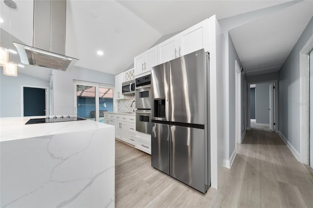 5015 Nassau Cir Unit 4, Orlando, FL 32808 - kitchen featuring stainless steel appliances, light wood-style flooring, lofted ceiling, white cabinetry, and light stone counters