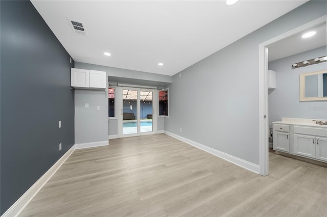 5015 Nassau Cir Unit 4, Orlando, FL 32808 - unfurnished room with light wood-style floors, baseboards, recessed lighting, and a sink