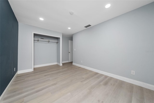 5015 Nassau Cir Unit 4, Orlando, FL 32808 - unfurnished bedroom with light wood-style flooring, baseboards, recessed lighting, and a closet