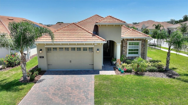 1101 Downswing Pl, Davenport, FL 33896 - mediterranean / spanish house featuring an attached garage, stucco siding, a tile roof, and stone siding