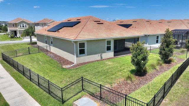 1101 Downswing Pl, Davenport, FL 33896 - view of property exterior featuring stucco siding, a tile roof, roof mounted solar panels, and a residential view