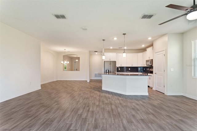 1101 Downswing Pl, Davenport, FL 33896 - kitchen featuring appliances with stainless steel finishes, open floor plan, wood finished floors, and recessed lighting