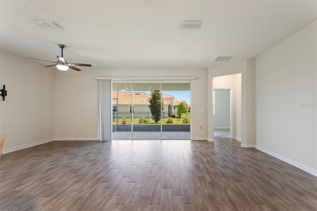 1101 Downswing Pl, Davenport, FL 33896 - unfurnished room featuring dark wood finished floors, a ceiling fan, and baseboards
