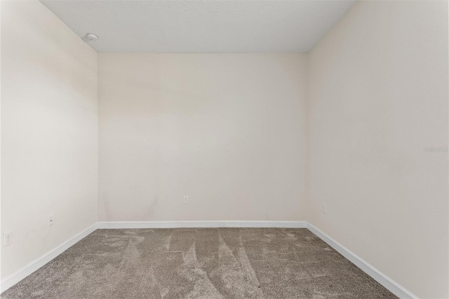 1101 Downswing Pl, Davenport, FL 33896 - empty room with carpet, baseboards, and a smoke detector