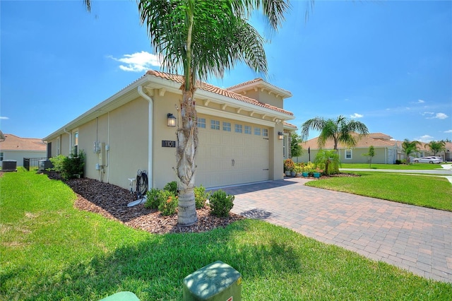 1101 Downswing Pl, Davenport, FL 33896 - view of property exterior featuring stucco siding, a yard, decorative driveway, cooling unit, and a garage